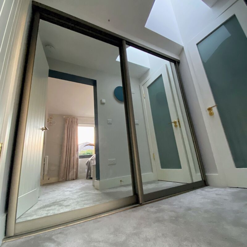 A fixed skylight in a chimney brings light to Jennifer's windowless hallway.