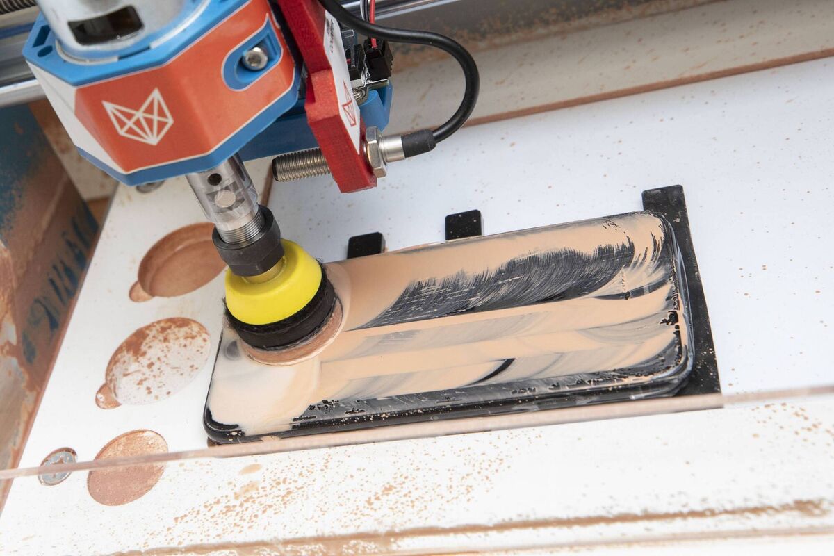 A phone screen is professionally polished as part of the refurbishment process