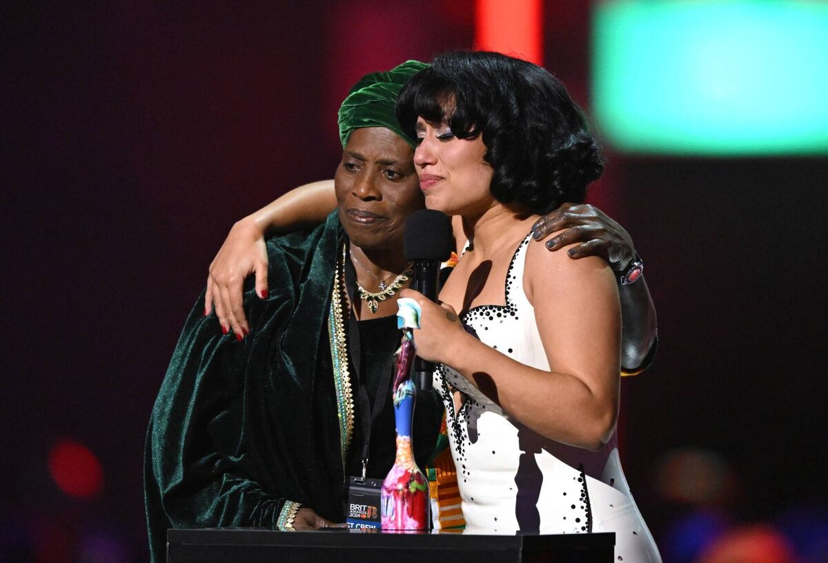 Raye accepts the Album Of The Year award for My 21st Century Blues on stage with grandmother Agatha Dawson-Amoah. (Photo by Gareth Cattermole/Getty Images)