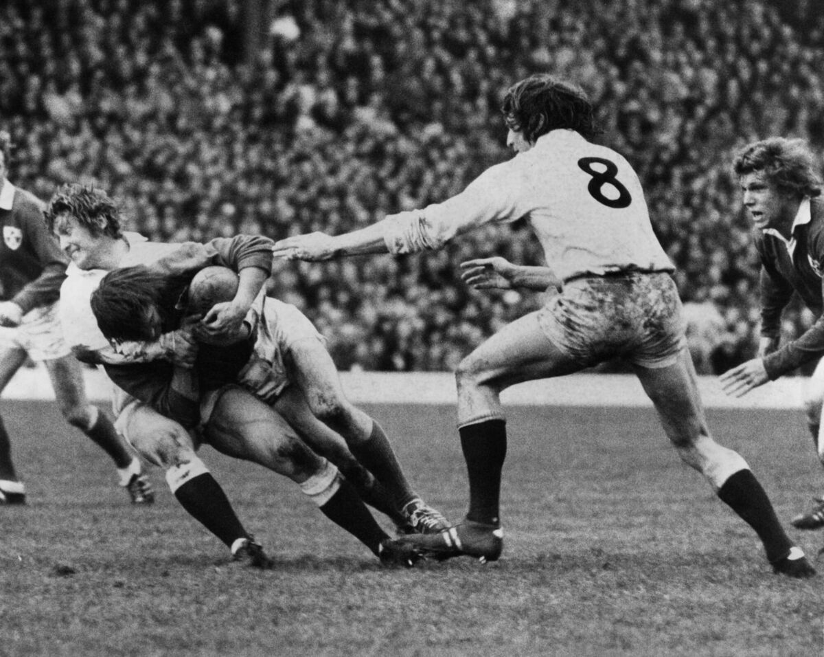 1974: Ireland's scrum-half Johnny Moloney tackled by England's Steve Smith. 