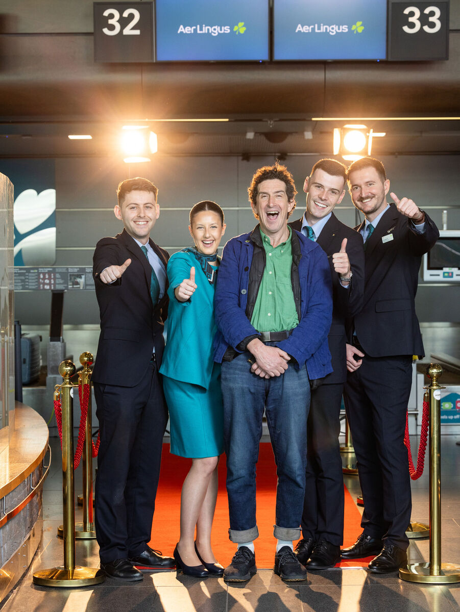 Robbie Ryan (centre) with Aer Lingus staff as he checks in for flight EI069 to Los Angeles, ahead of the Academy Awards where he is nominated for Best Cinematography for the film Poor Things. Picture: Naoise Culhane