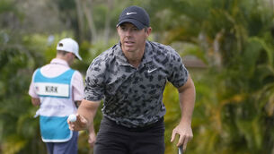 <p>SAVING GRACE: Rory McIlroy of Northern Ireland shows his ball after making a birdie putt. Pic; Marta Lavandier, AP</p>