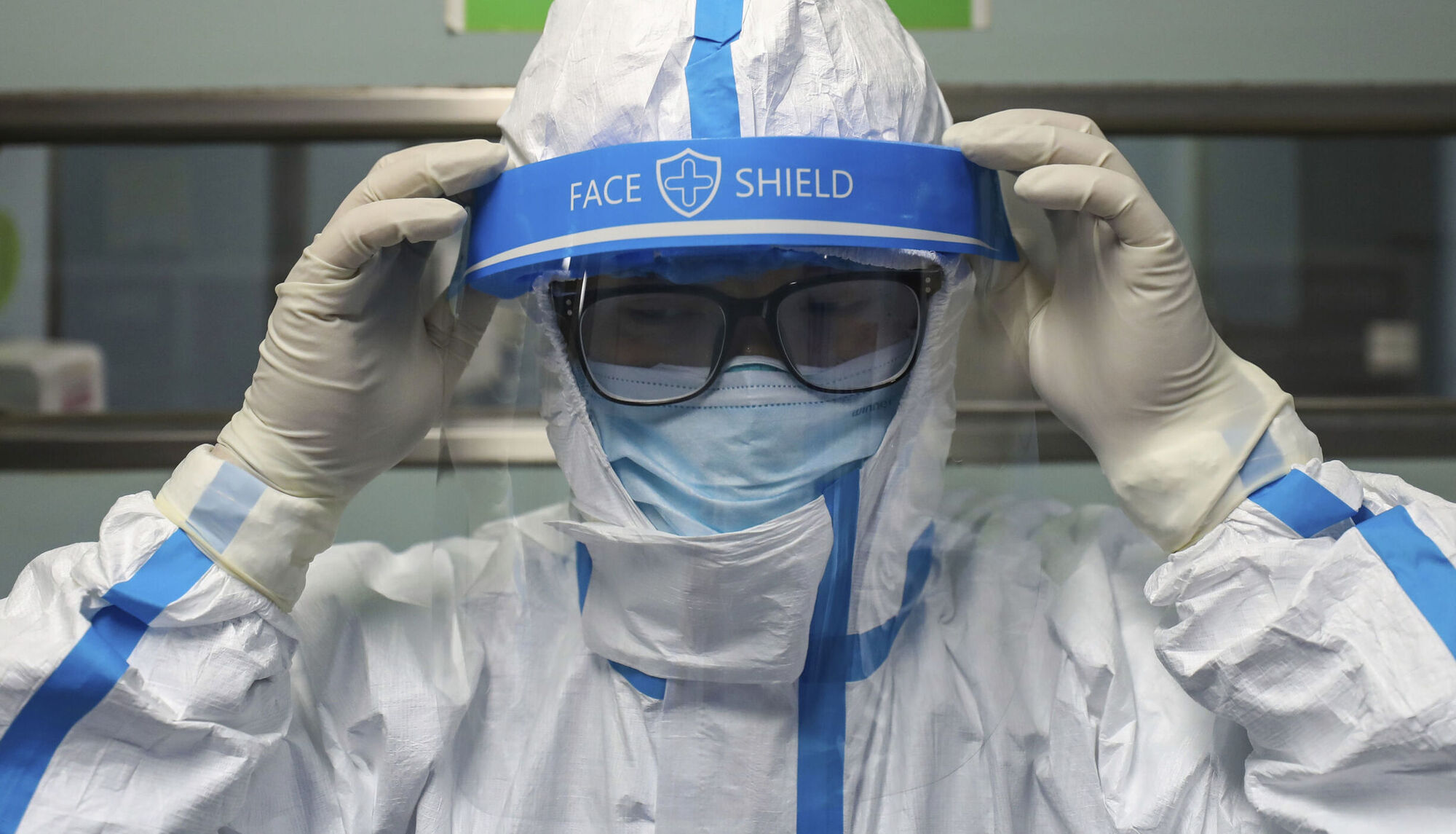 A doctor in an isolation outfit in Jinyintan Hospital in Wuhan on February 13, 2020. By the time Wuhan was sealed off, as many as half a million people had left for the Lunar New Year holiday — an echo of the decision to proceed with the Cheltenham Festival in March 2020. Chinatopix/AP