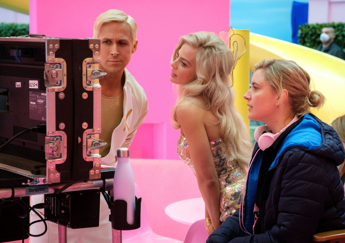 Ryan Gosling, left, Margot Robbie, centre, with director Greta Gerwig on the set of Barbie. Picture: Jaap Buitendijk/Warner Bros. Pictures via AP Ryan Gosling, left, Margot Robbie, centre, with director Greta Gerwig on the set of Barbie. Picture: Jaap Buitendijk/Warner Bros. Pictures via AP