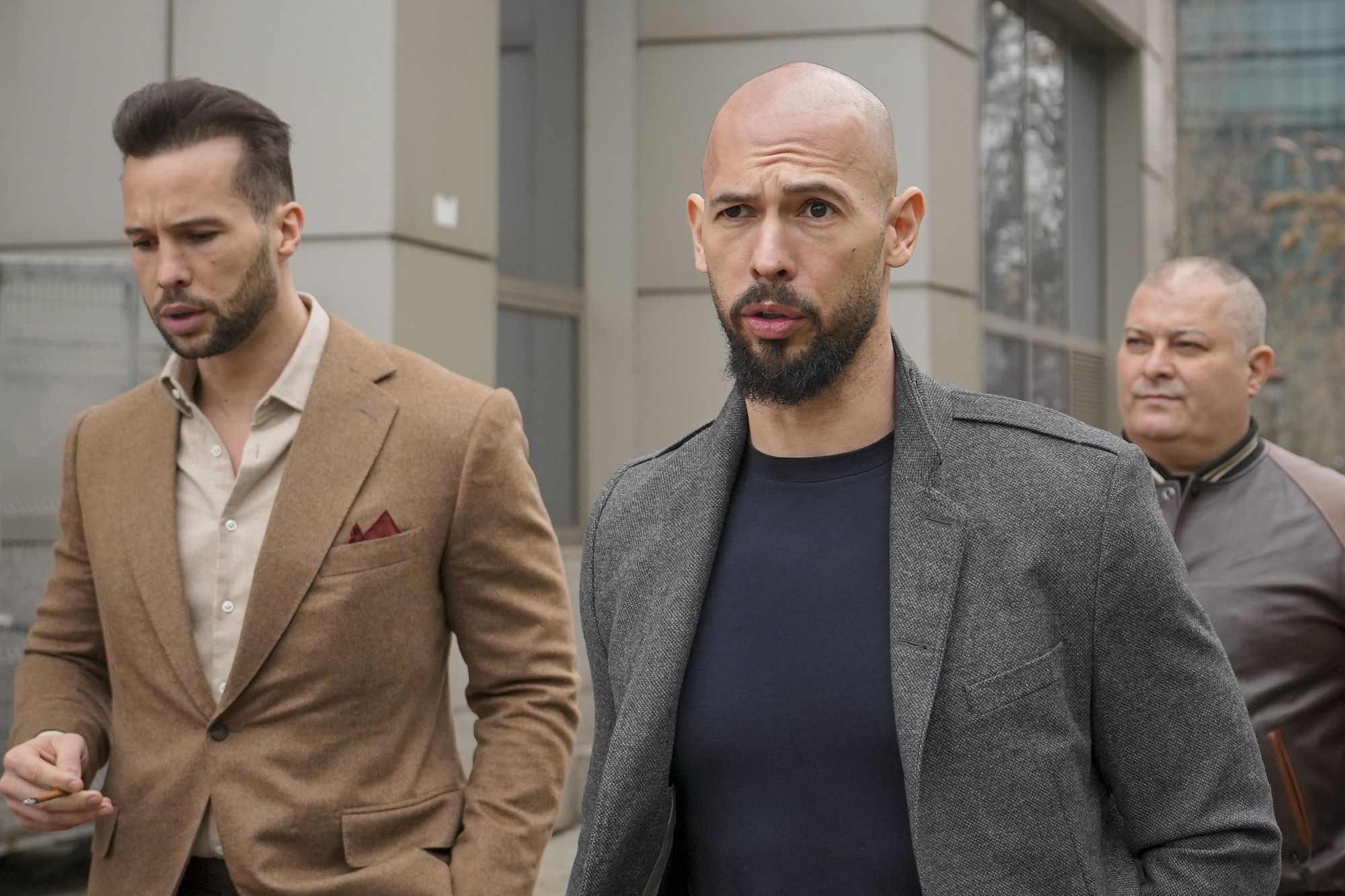 Andrew Tate handed UK arrest warrant after being detained in Romania