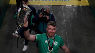 <p>Ireland's Peter O'Mahony makes his way down the tunnel holding the Guinness Six Nations trophy. Pic: Brian Lawless/PA Wire. </p>
