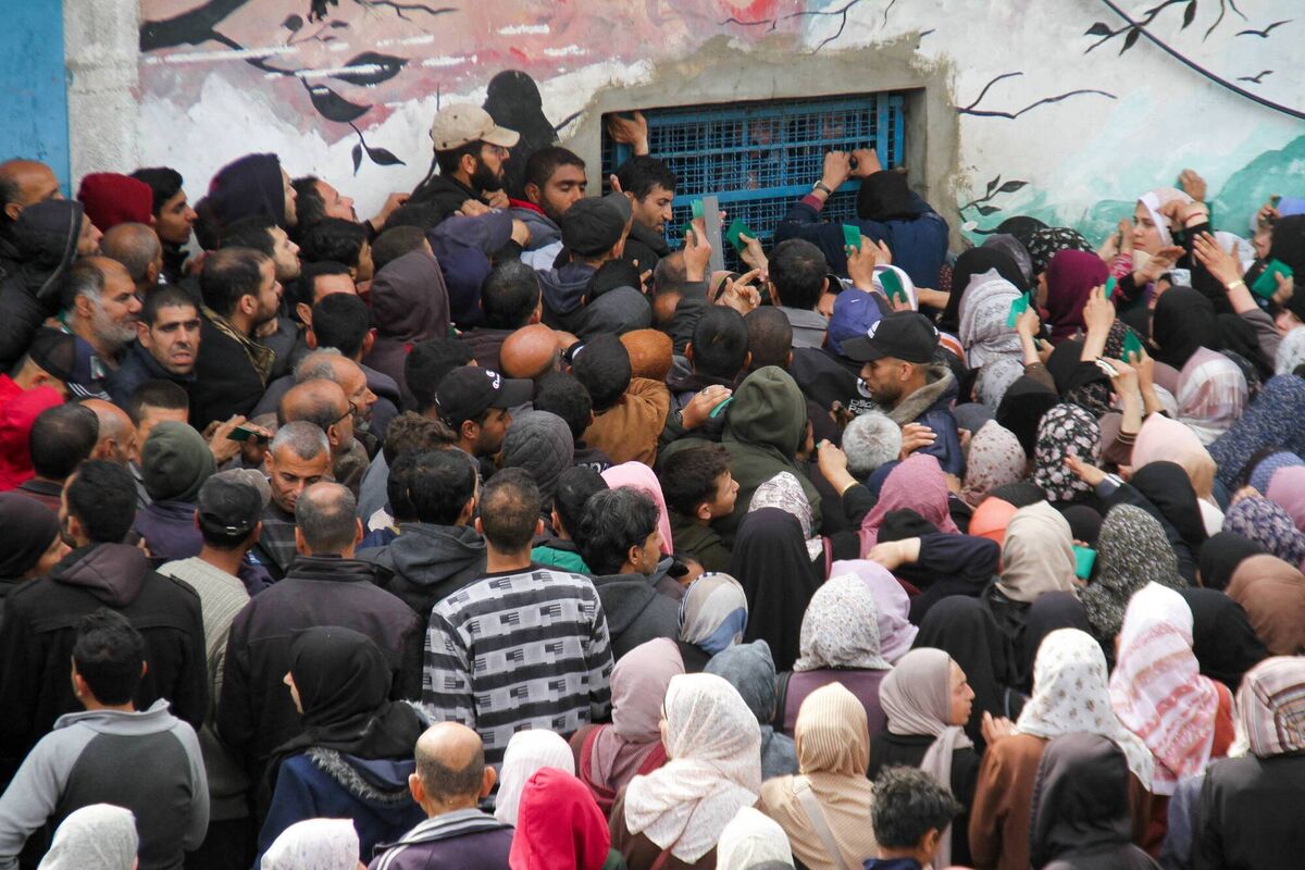 Palestinians gather to receive aid outside an UNRWA warehouse as Gaza residents face crisis levels of hunger, amid the ongoing conflict between Israel and Hamas, in Gaza City March 18, 2024. REUTERS/Mahmoud Issa Palestinians gather to receive aid outside an UNRWA warehouse as Gaza residents face crisis levels of hunger, amid the ongoing conflict between Israel and Hamas, in Gaza City March 18, 2024. REUTERS/Mahmoud Issa