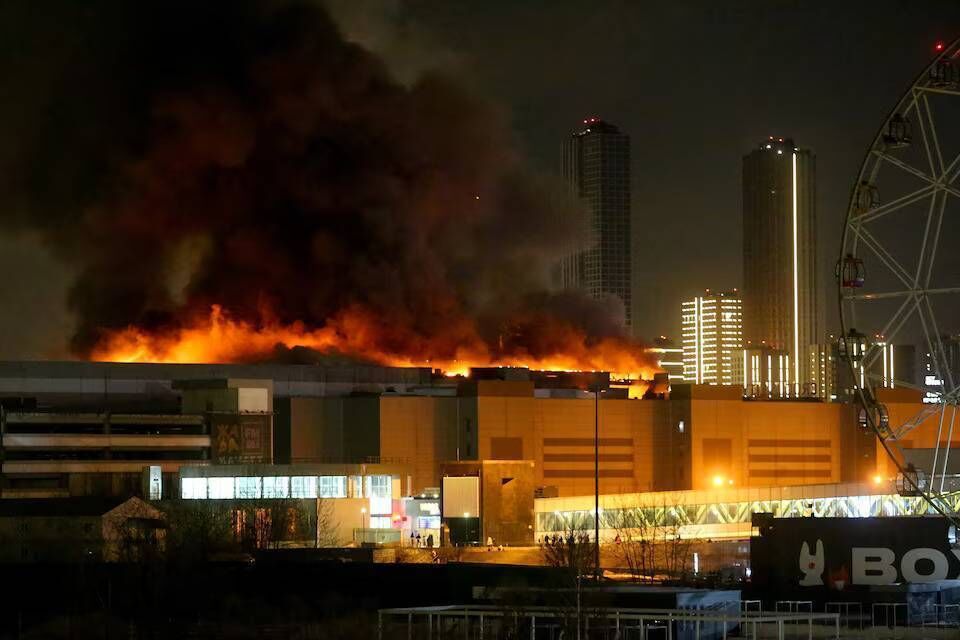 Smoke rises above the burning Crocus City Hall concert venue outside Moscow, Russia, March 22. Sergei Vedyashkin/Moscow News Agency/Handout via REUTERS