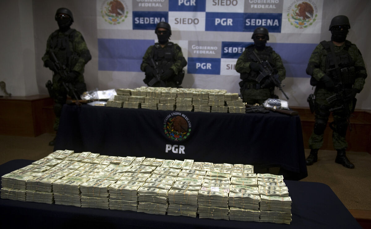 Mexican army soldiers stand by a haul of more than $15m sized from alleged members of the Guzmán Loera drug cartel. Picture: Yuri Cortez/AFP/Getty Mexican army soldiers stand by a haul of more than $15m sized from alleged members of the Guzmán Loera drug cartel. Picture: Yuri Cortez/AFP/Getty