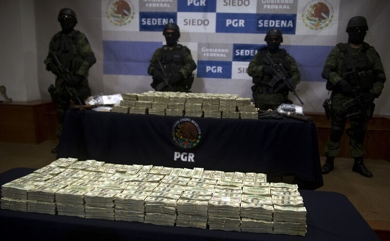Mexican army soldiers stand by a haul of more than $15m sized from alleged members of the Guzmán Loera drug cartel. Picture: Yuri Cortez/AFP/Getty