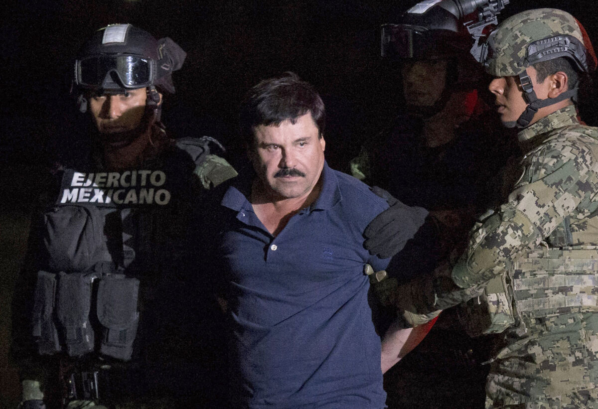 Mexican drug lord Joaquín 'El Chapo' Guzmán is escorted by soldiers to a waiting helicopter in Mexico City in 2016 after he escaped a maximum security prison. Picture: Rebecca Blackwell/AP Mexican drug lord Joaquín 'El Chapo' Guzmán is escorted by soldiers to a waiting helicopter in Mexico City in 2016 after he escaped a maximum security prison. Picture: Rebecca Blackwell/AP