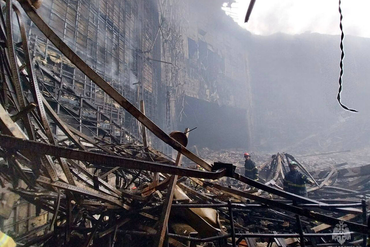 Firefighters work in the burned concert hall after an attack on the building of the Crocus City Hall on the western edge of Moscow, Russia. (Russian Emergency Ministry Press Service via AP)