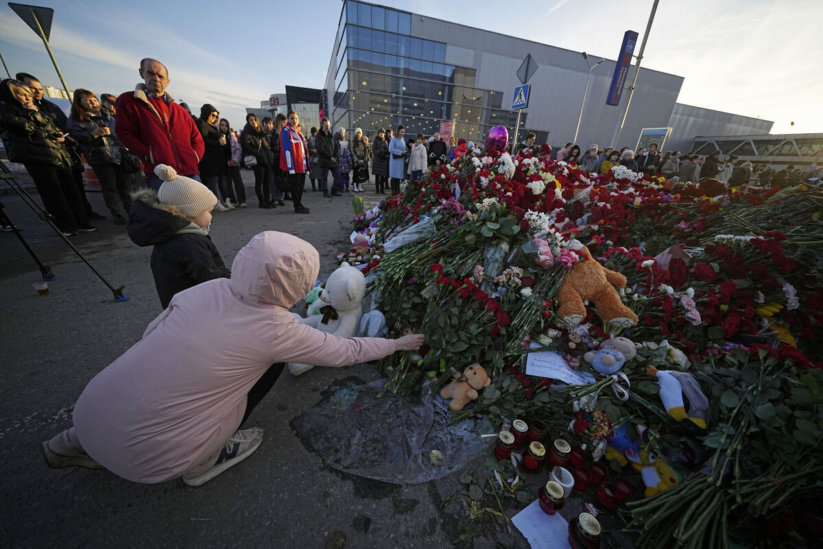 People lay flowers at a makeshift memorial in front of the Crocus City Hall. Picture: AP Photo/Alexander Zemlianichenko People lay flowers at a makeshift memorial in front of the Crocus City Hall. Picture: AP Photo/Alexander Zemlianichenko