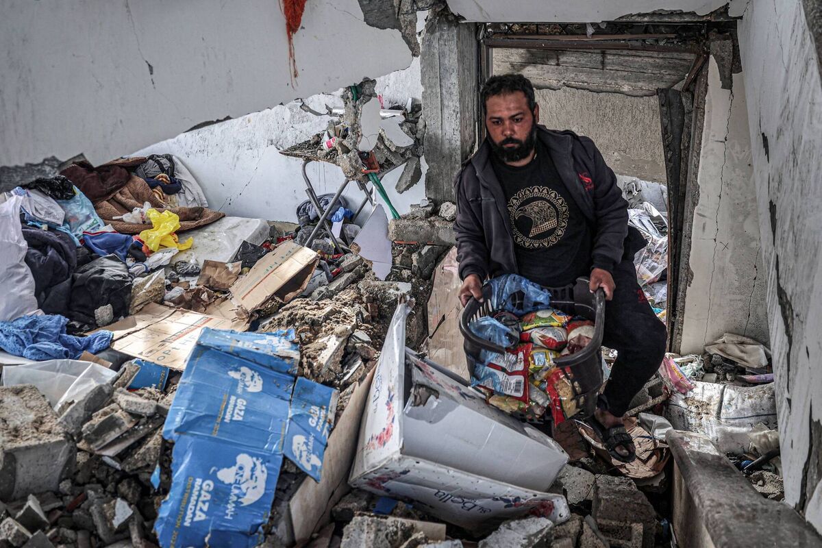 A man salvages food packages from a building that was hit overnight during Israeli bombardment in Rafah in the southern Gaza Strip on March 26, 2024 amid the ongoing conflict in the Palestinian territory between Israel and the militant group Hamas. 