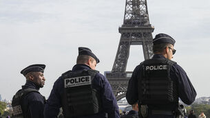 Police officers patrol the Trocadero plaza near the Eiffel Tower in Paris (Michel Euler/AP)