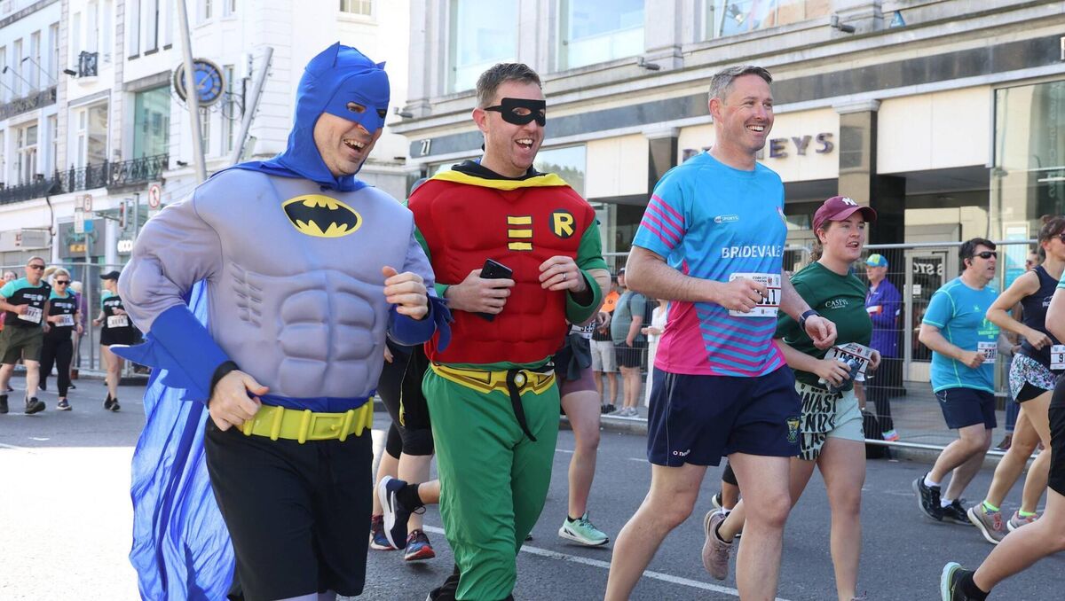 Runners dressed as Batman and Robin at the 2023 Cork City Marathon, soaking up the holiday atmosphere under a clear blue sky. Runners dressed as Batman and Robin at the 2023 Cork City Marathon, soaking up the holiday atmosphere under a clear blue sky.