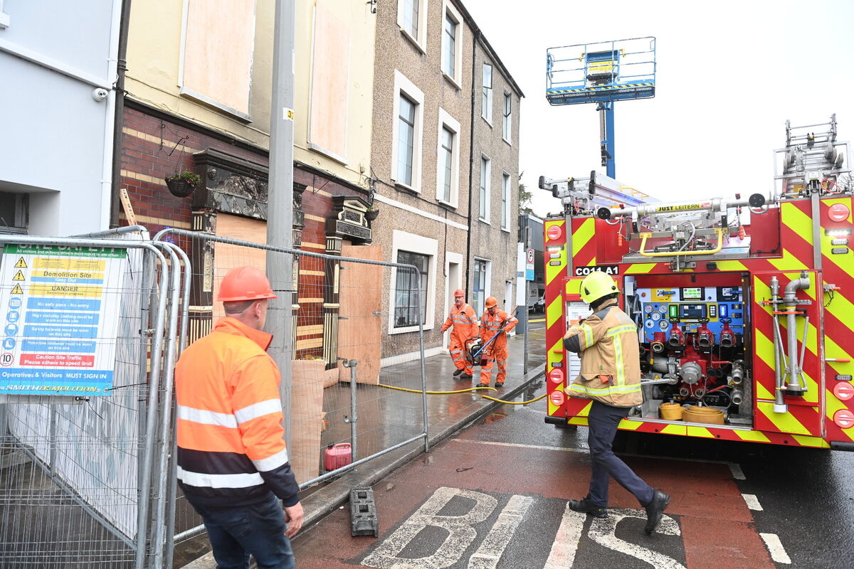 Firefighters had to to return to the scene of the fatal fire at 6pm on Friday as smoke was again seen coming from the building. Picture: Larry Cummins Firefighters had to to return to the scene of the fatal fire at 6pm on Friday as smoke was again seen coming from the building. Picture: Larry Cummins