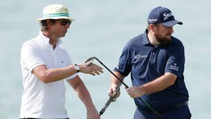 <p>ABU DHABI, UNITED ARAB EMIRATES - JANUARY 18: Shane Lowry of Ireland swaps clubs with his coach Neil Manchip during a practice round prior to the Abu Dhabi HSBC Championship at Yas Links Golf Course on January 18, 2022 in Abu Dhabi, United Arab Emirates. (Photo by Oisin Keniry/Getty Images)</p>