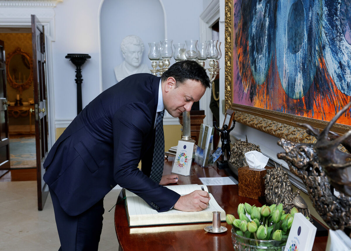 Leo Varadkar signing the guest book before meeting with President Michael D Higgins to present his resignation. Picture: Maxwells/PA Wire