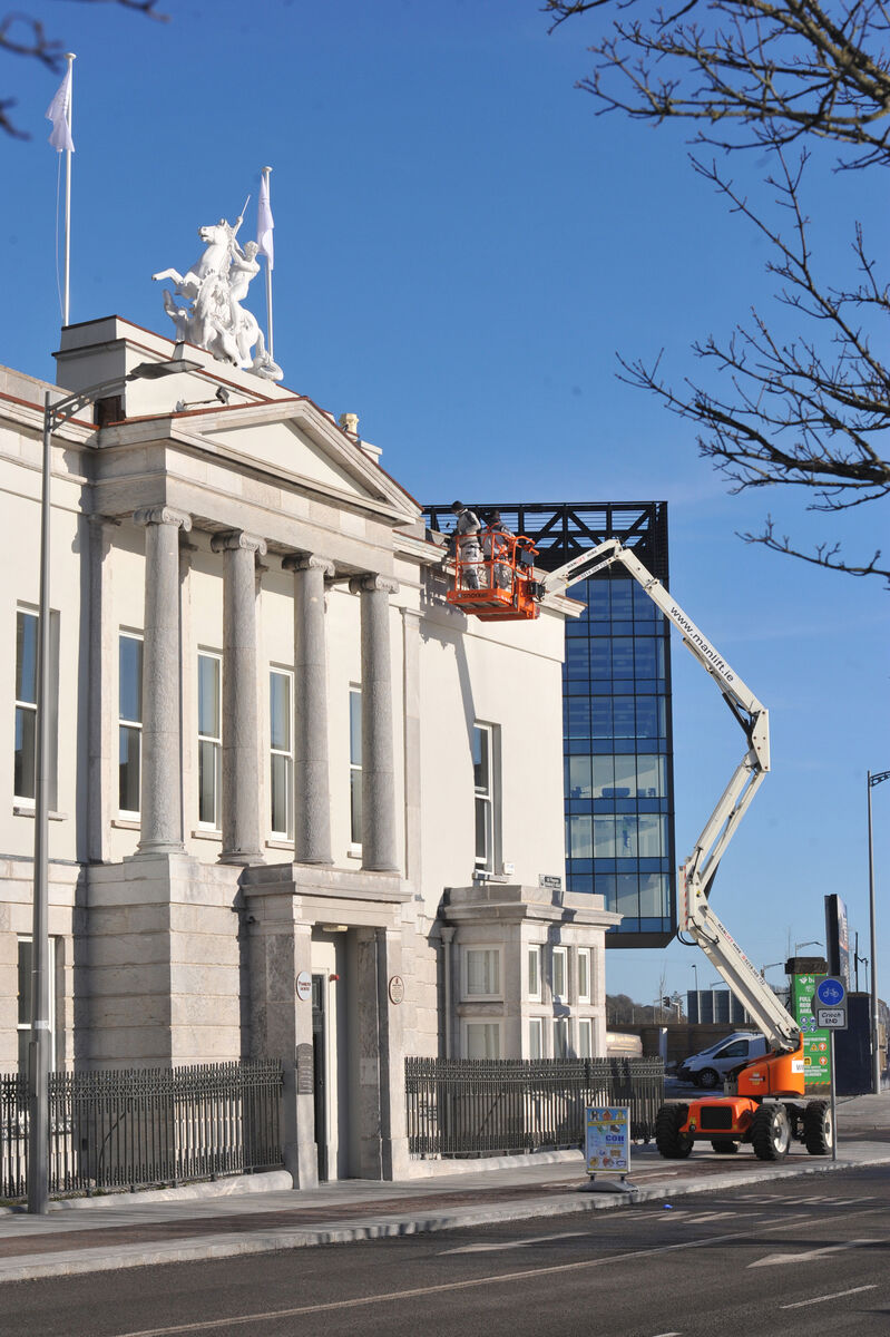 Working at height. Workers on a platform working on the roof of Penrose House, Penrose Quay, in 2021. Working at height. Workers on a platform working on the roof of Penrose House, Penrose Quay, in 2021.