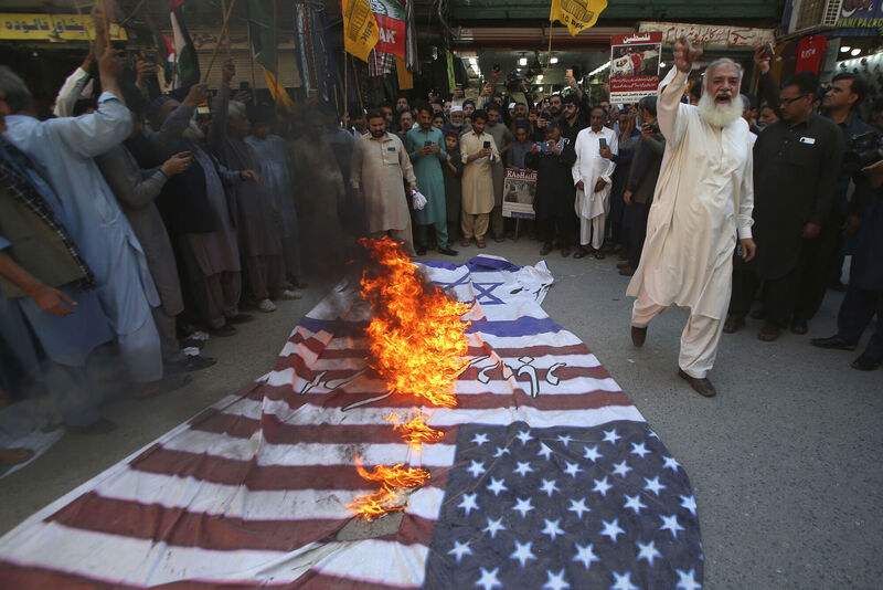 Shiite Muslims chat slogans after burning representations of US and Israeli flags during the annual Al-Quds, or Jerusalem, Day demonstration in Peshawar, Pakistan, Friday. Picture: AP Photo/Muhammad Sajjad)