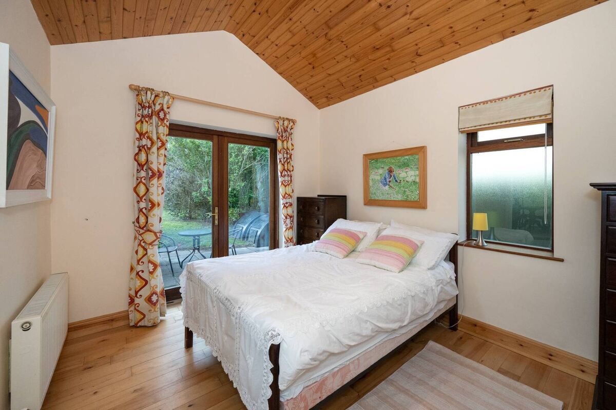 Downstairs bedroom with doors to the patio Downstairs bedroom with doors to the patio