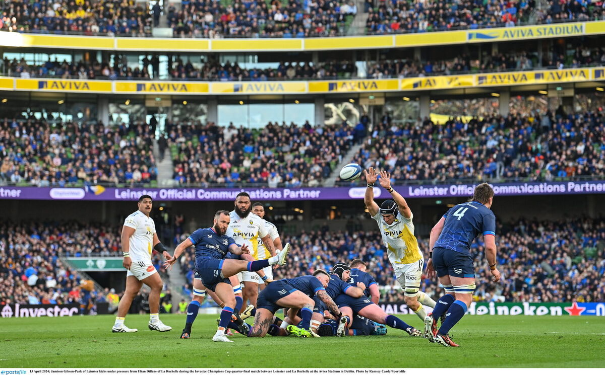 Jamison Gibson-Park of Leinster kicks under pressure from Ultan Dillane. Photo by Ramsey Cardy/Sportsfile