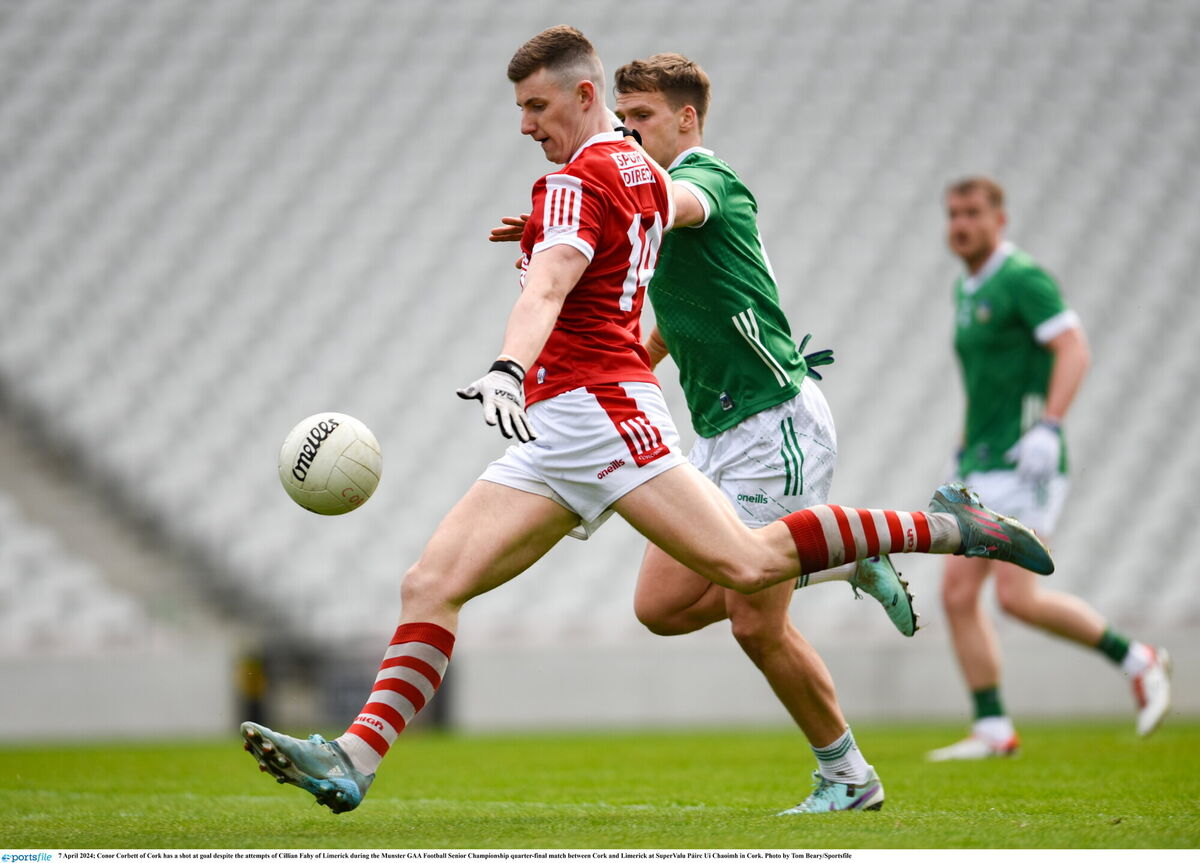 Conor Corbett of Cork has a shot at goal despite the attempts of Cillian Fahy of Limerick. Pic: Tom Beary, Sportsfile