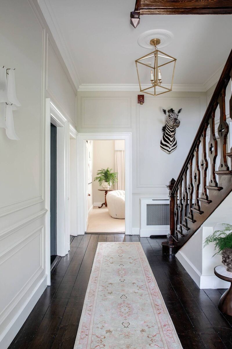 To create additional light, the team chased the solid walls in the entrance hallway to create a pathway of light using the Dahlia wall lights from Bella Figura, London.