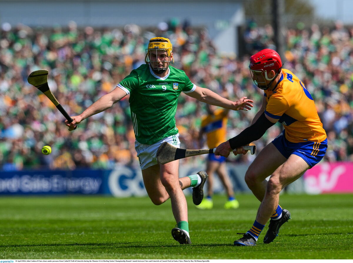 John Conlon of Clare clears under pressure from Cathal O'Neill of Limerick. Pic: Ray McManus, Sportsfile John Conlon of Clare clears under pressure from Cathal O'Neill of Limerick. Pic: Ray McManus, Sportsfile