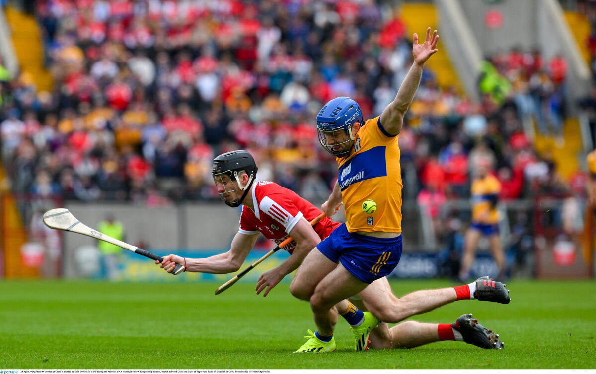 INSIDE BATTLE: Shane O'Donnell of Clare is tackled by Eoin Downey of Cork. Pic: Ray McManus, Sportsfile