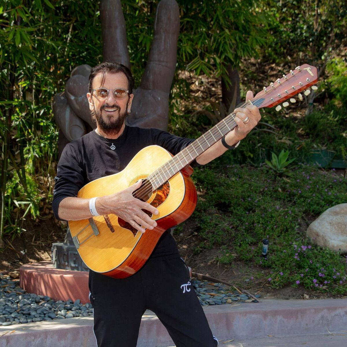 Ringo Starr poses with John Lennon's long-lost guitar. Picture: Scott Ritchie