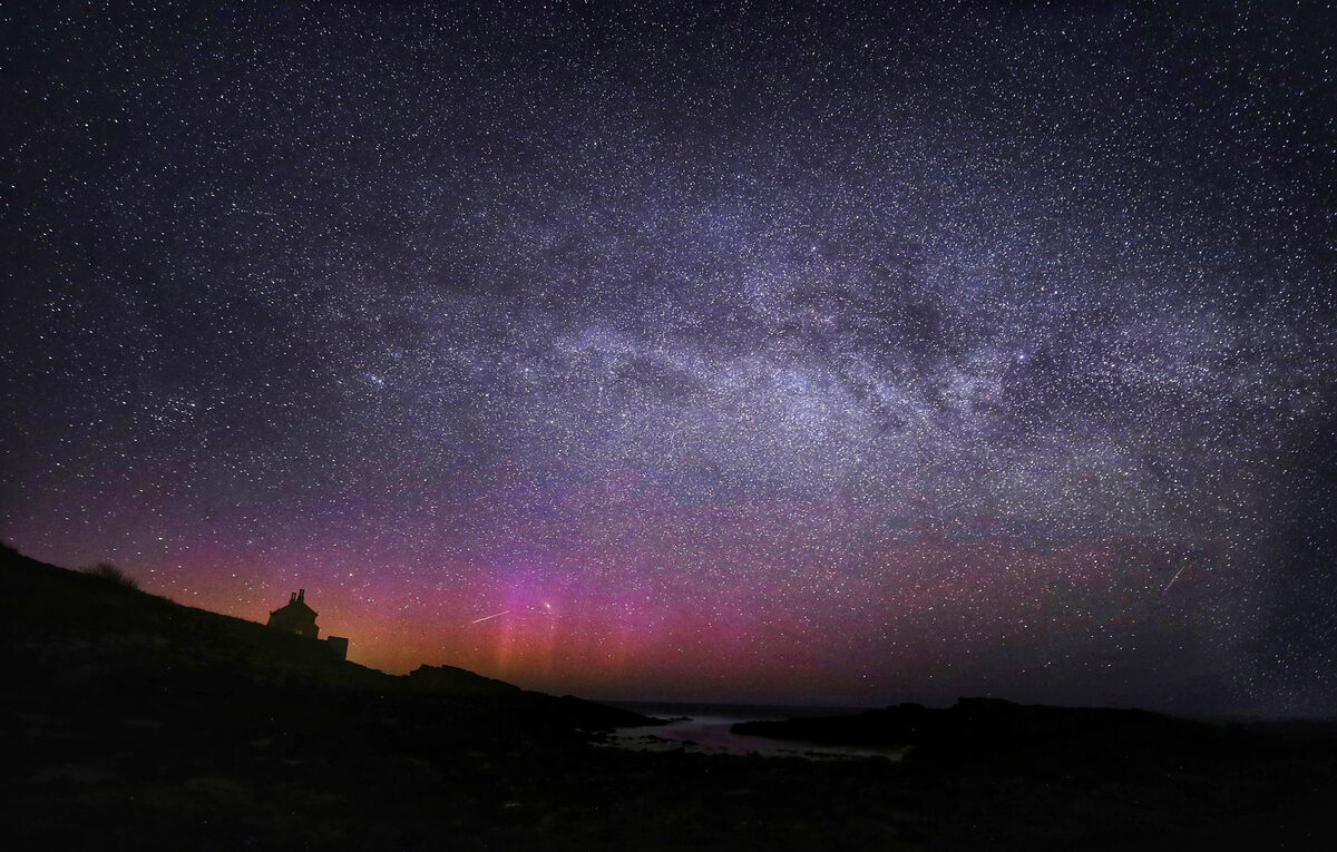 The Northern Lights, the Milky Way and Lyrid meteors falling through the sky at the Bathing House near Howick, Northumberland, as the Lyrid meteor shower reached its peak.