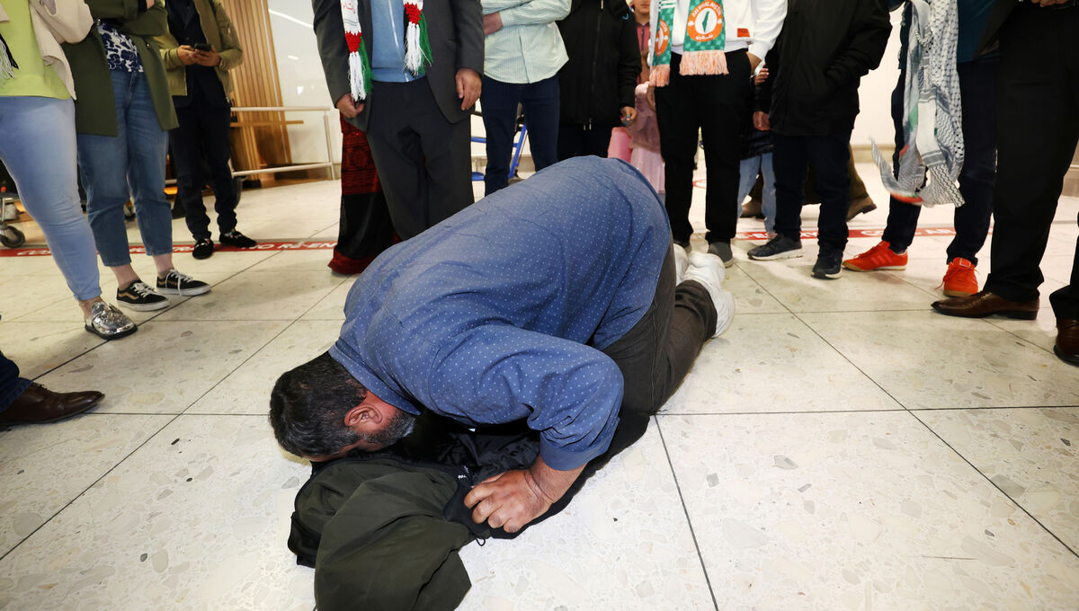  Irish-Palestinian man Zak Hania kisses the ground in Dublin Airport as he returns from Palestine, Picture: Leah Farrell/ RollingNews.ie