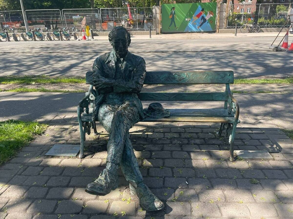 The sculpture of poet Patrick Kavanagh on Dublin's Grand Canal photographed on Sunday as homeless asylum seekers pitched tents nearby. Picture: Alison O'Reilly