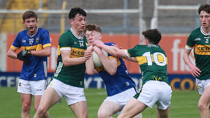 <p>FINAL BOUND: Tom Corcoran of Tipperary, tightly holding possession against Gearoid White and Ronan Carroll of Kerry. Picture: Brendan Gleeson</p>
