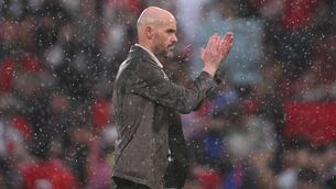 <p>Erik ten Hag, Manchester United manager, leaves the field in the rain following defeat to Arsenal. Pic:  Stu Forster/Getty Images</p>