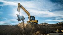 Construction - digger working at building site on sunny day