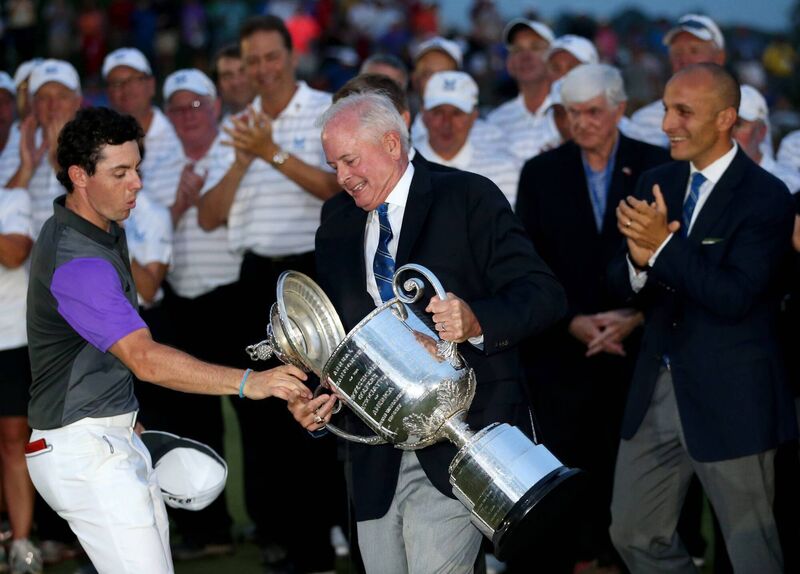 Rory McIlroy catches the lid of the Wanamaker trophy as PGA of America President, Ted Bishop, holds the trophy. Picture: Andrew Redington/Getty Images