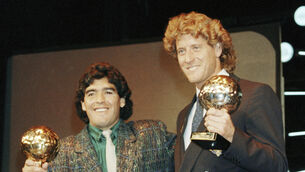 <p>Argentina’s Diego Maradona, left, and West German goalkeeper Harald Schumacher holding their awards during the Soccer Golden Shoe Award ceremony in Paris, France, in November 1986 (Michael Lipchitz/Ap)</p>