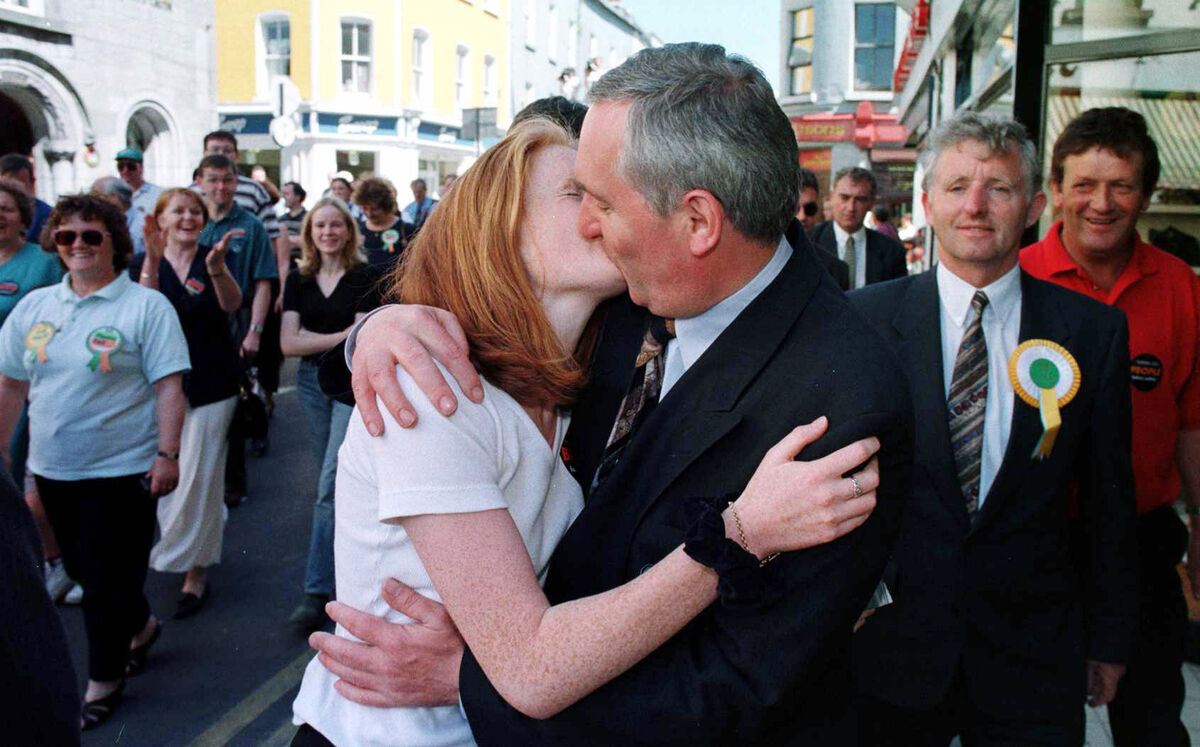 Fianna Fáil leader Bertie Ahern receives a kiss from a young admirer during his walkabout in Galway city centre before the 1997 General Election.