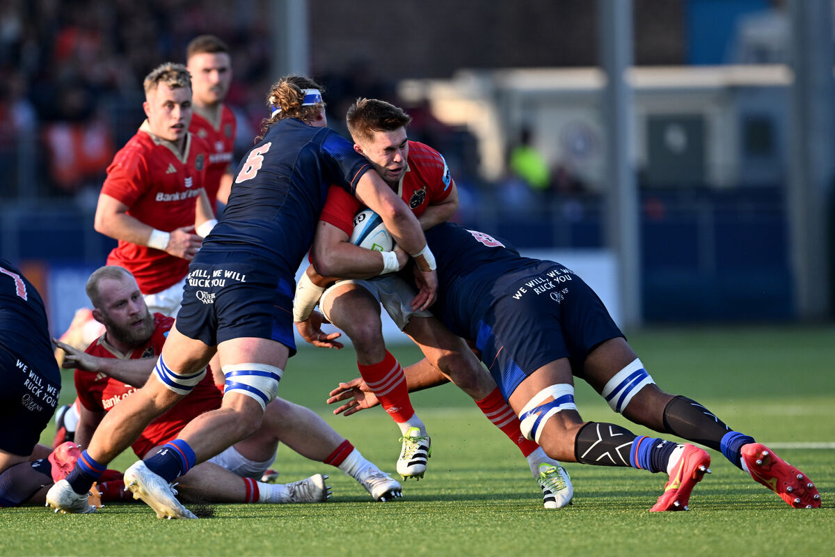 Munster’s Jack Crowley tackled by Jamie Ritchie and Viliame Mata of Edinburgh. Pic: Craig Watson
