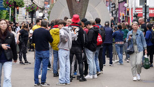<p>Fans gather next to a replica of the Europa League trophy near the Dublin-New York portal on North Earl Street, Dublin. Pictures: Brian Lawless/PA Wire.</p>