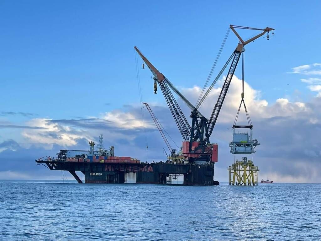 The Balder, one of the largest vessels of its type in the world, is shown lifting one of two 1,200 tonne substation platforms onto its foundation at the Neart na Gaoithe offshore wind farm off the east coast of Scotland.