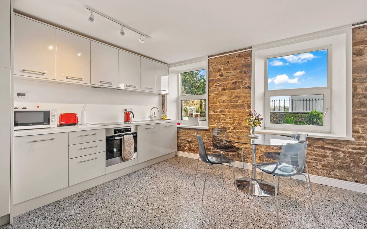 Exposed brick wall in basement kitchen Exposed brick wall in basement kitchen