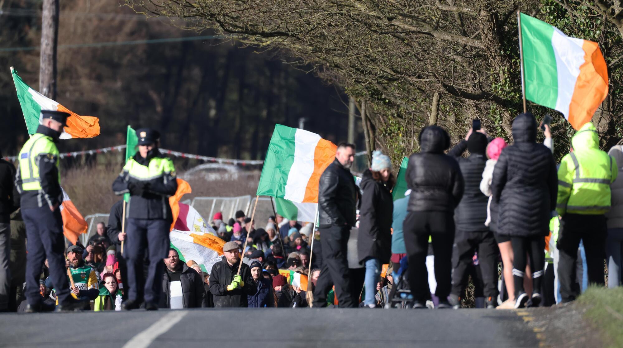 Gardaí watch as hundreds of anti migrant protesters gather in Kildare.