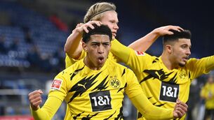 <p>Dortmund's Norwegian forward Erling Braut Haaland celebrates scoring with Jude Bellingham and Jadon Sancho during a 2021 Bundesliga game. Picture: INA FASSBENDER/AFP via Getty Images</p>