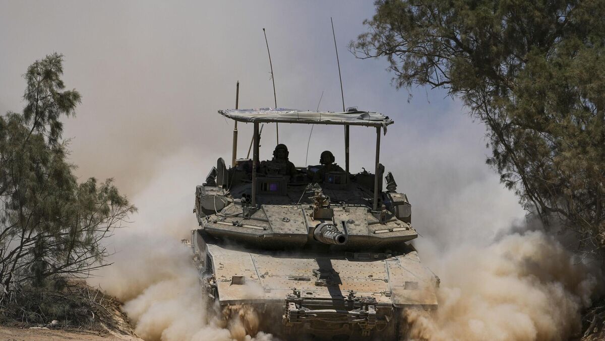 Israeli soldiers drive a tank near the Israeli-Gaza border, in southern Israel, on Wednesday. Picture: Tsafrir Abayov/AP