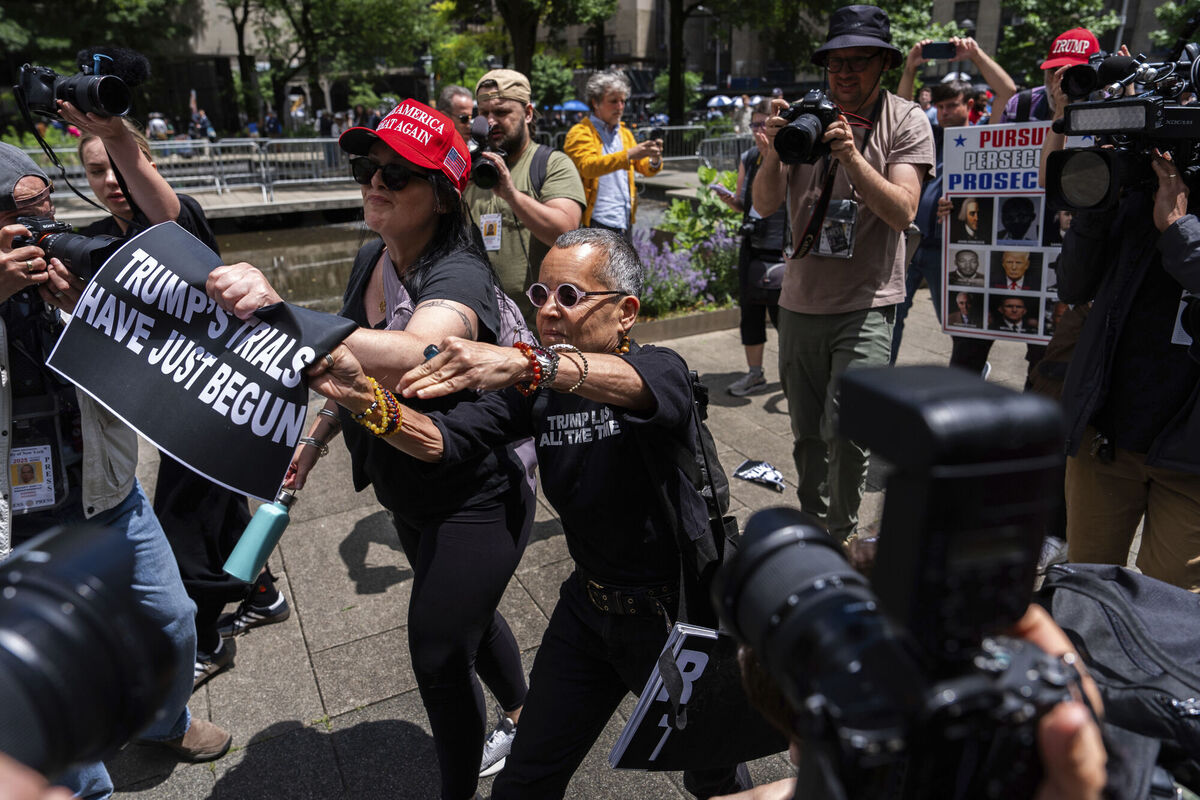 A supporter of former President Donald Trump and an anti-Trump protester fight outside Manhattan Criminal Court, Thursday, May 30, 2024, in New York. (AP Photo/Julia Nikhinson)