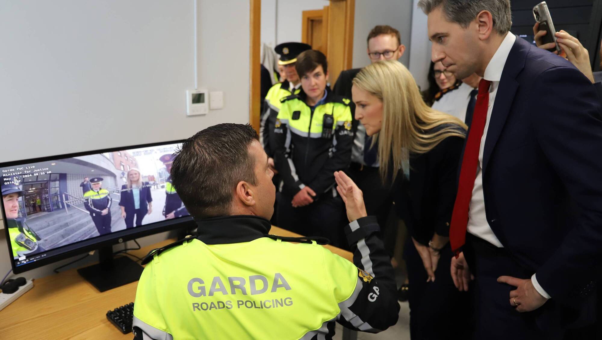Taoiseach Simon Harris and Justice Minister Helen McEntee watch a demonstration of how footage from the new bodyworn cameras will be uploaded. They were in Store St Garda Station for the launch of the pilot phase of the new bodycam system. Picture: GIS